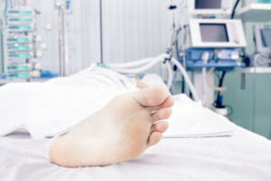 a person with a broken foot lying on a hospital bed