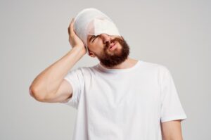 A man with a bandage over his head and part of his face.