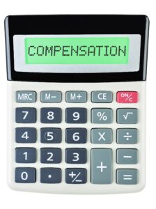 The word 'compensation' written on a pocket calculator.