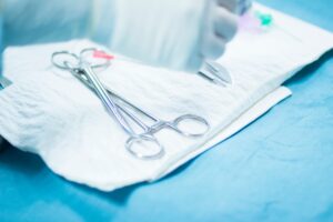 Sterile instruments sit on a cloth pad prepped for surgery.