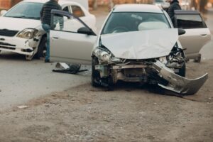 Two damaged vehicles on a road having been involved in a serious car accident