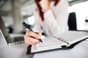 A solicitor at their desk making notes on their client's psychological injury claim