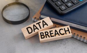 Two wooden blocks on a desk that read "data breach"