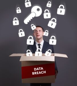 A man holding a box labelled data breach with locks and keys representing medical data floating out of it. 