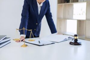 A personal injury solicitor standing at a desk.