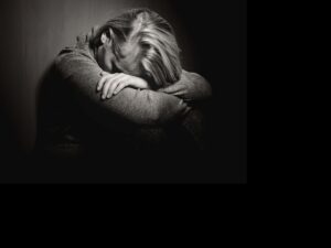 BLACK AND WHITE IMAGE OF PERSON SUFFERING FROM POST TRAUMATIC STRESS DISORDER