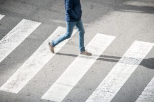 PEDESTRIAN USING A ZEBRA CROSSING