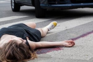 PEDESTRIAN LAYING ON FLOOR AFTER BEING INJURED BY A CAR