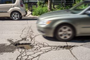 A car speeding towards a pothole in the road