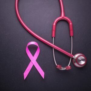 PINK RIBBON AND STETHOSCOPE TO INDICATE CANCER AWARENESS