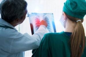 Doctor and radiologist review an x-ray to make an breast cancer diagnosis.