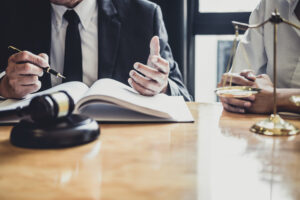 A male solicitor discussing the details of a claim with his client