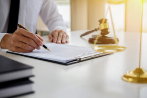 Specialist medical negligence solicitor writing on notepad.